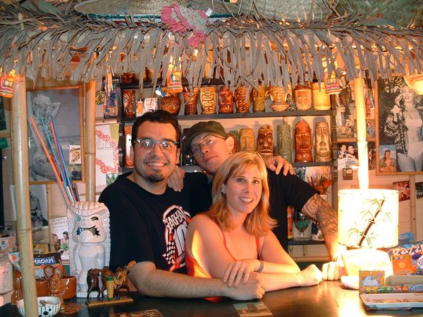 Mike LaVella and Michelle Haunold seated at a tiki bar in the Gearhead Records office.