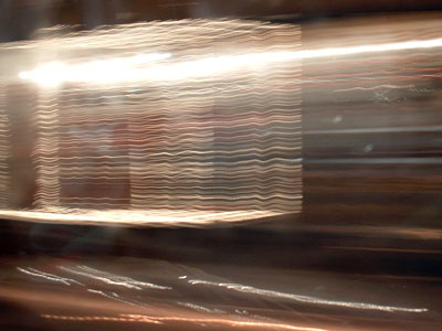 a picture of christmas lights taken from a moving bus